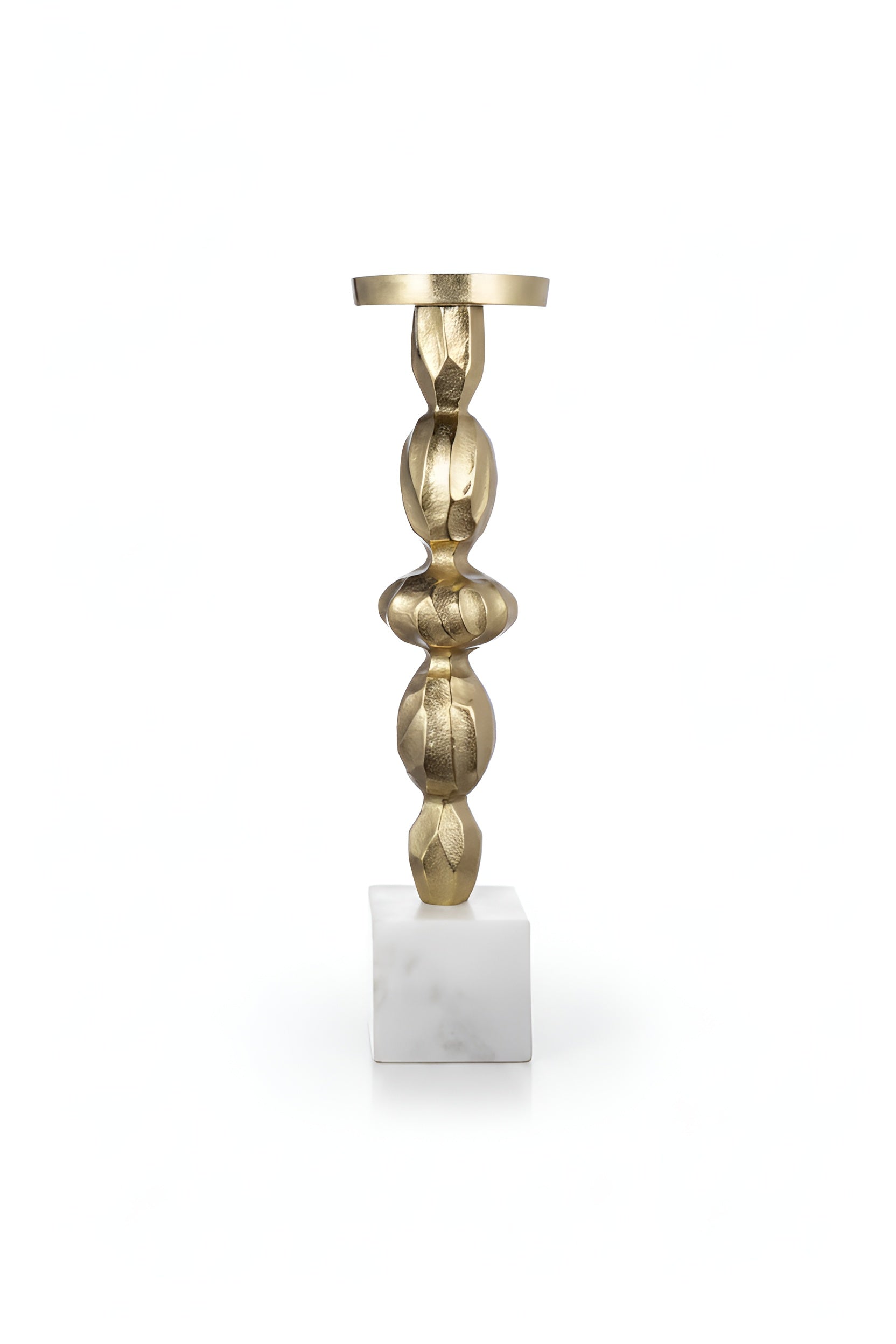 Brass candlestick holder with stacked bulbous design on white marble base