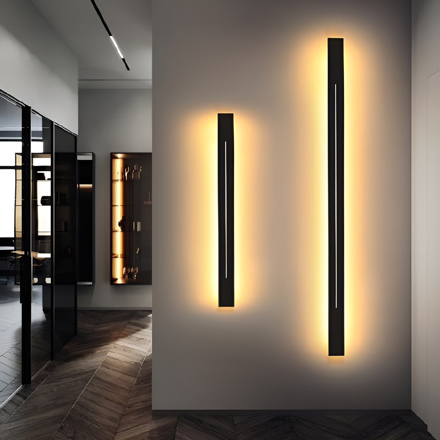 Modern black LED wall sconces with warm lighting in a contemporary hallway