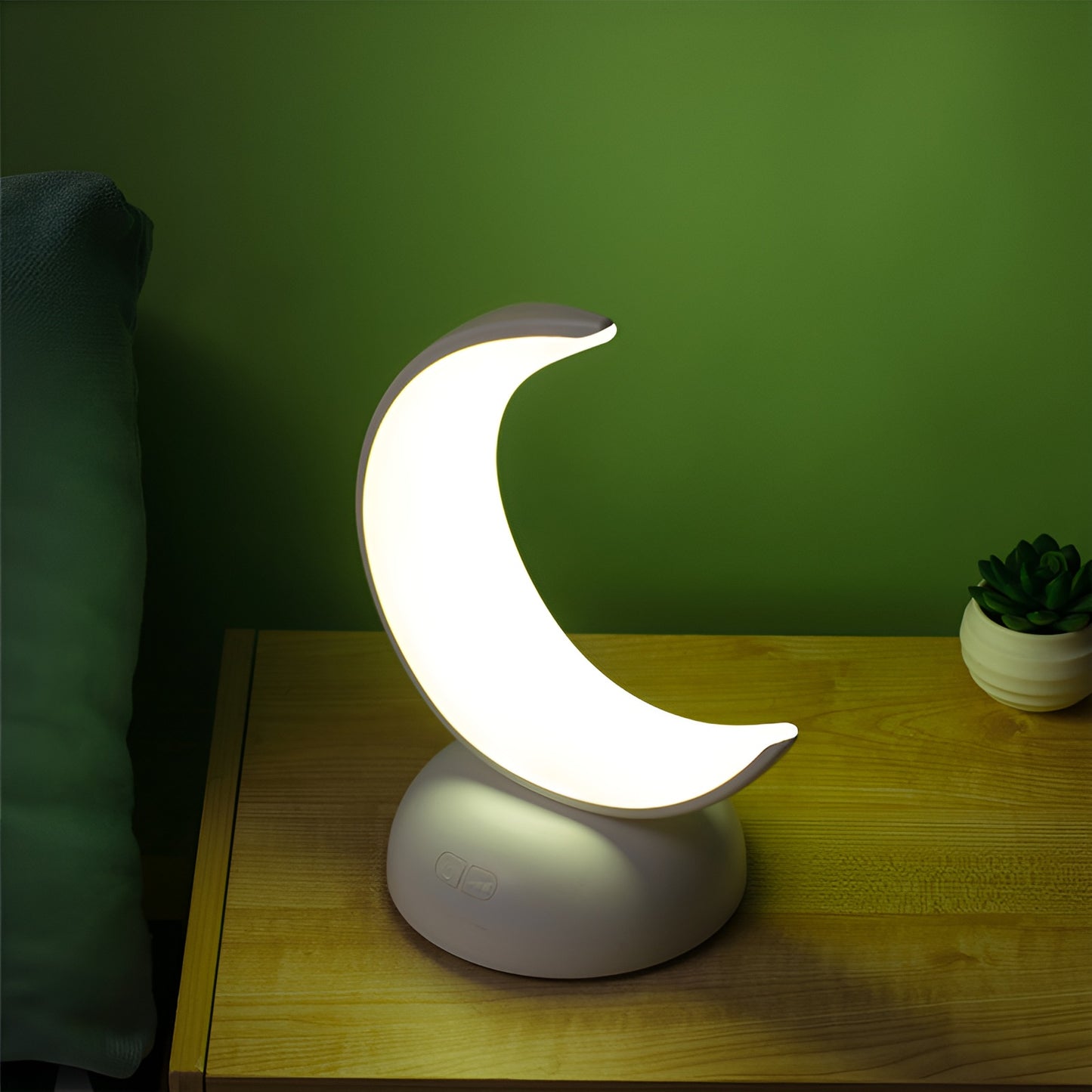 Crescent moon LED night light glowing on wooden bedside table